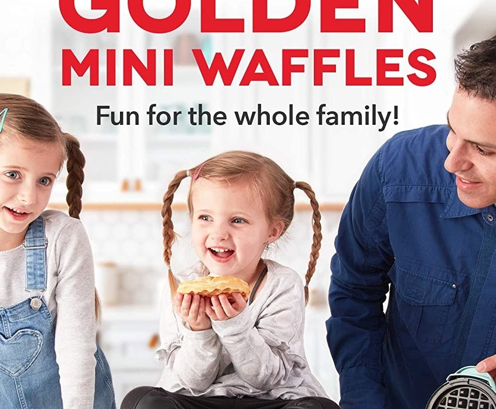The waffle maker sitting on a counter next to a child eating a waffle
