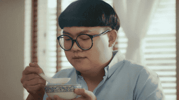 A cat asking a man why he is eating shark fin soup