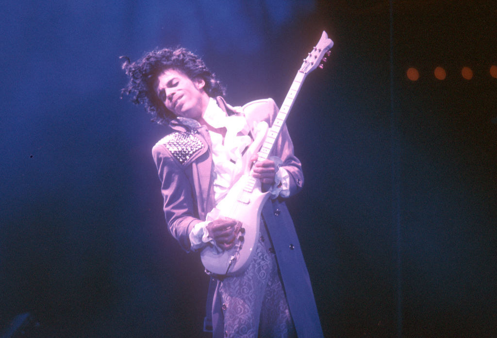 Prince playing the guitar.