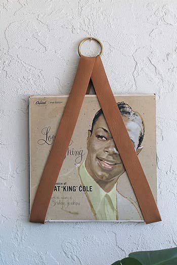 a record hanging in the leather holder
