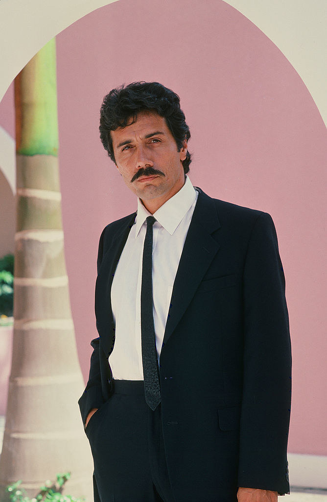 A young Edward James Olmos posing for the camera in a suit