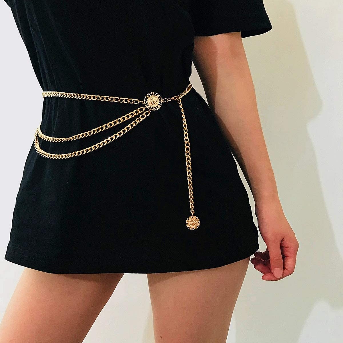 A person wearing the chain belt over a baggy t shirt dress