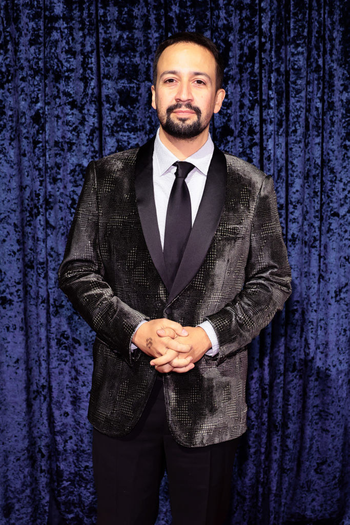 Lin-Manuel Miranda standing in front of a curtain