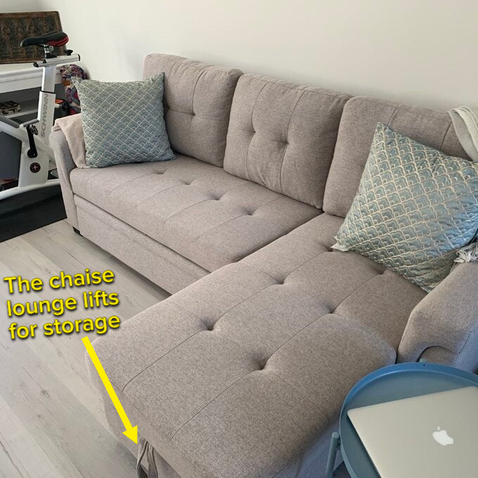 a reviewer shows the light gray sofa in their home