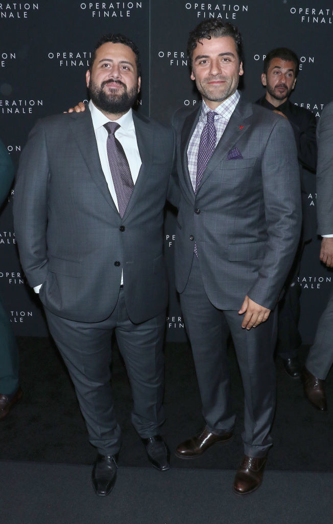 Michael and Oscar in suits and embracing on the red carpet