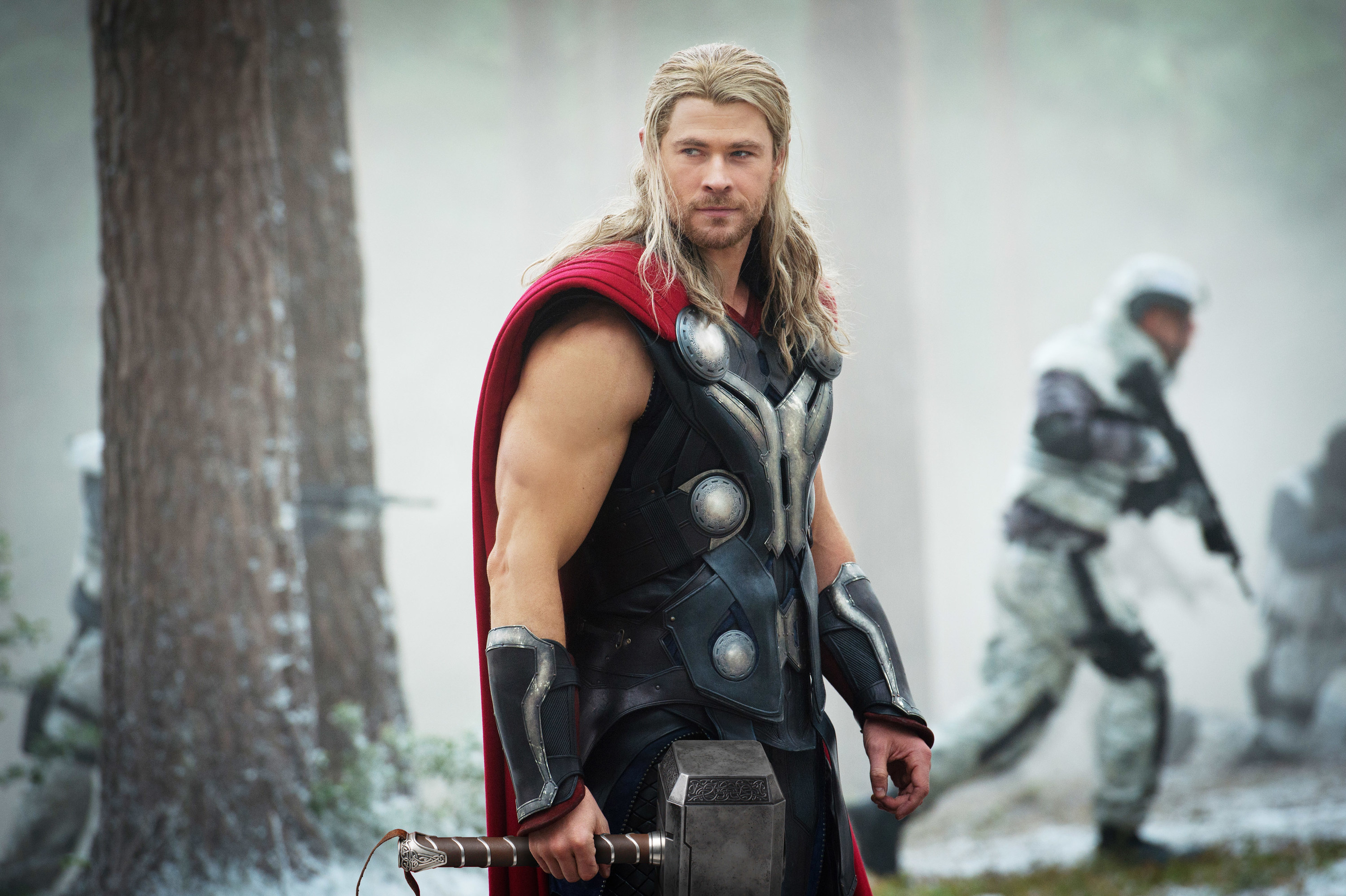 Chris as Thor wearing an armored suit and holding a large hammer