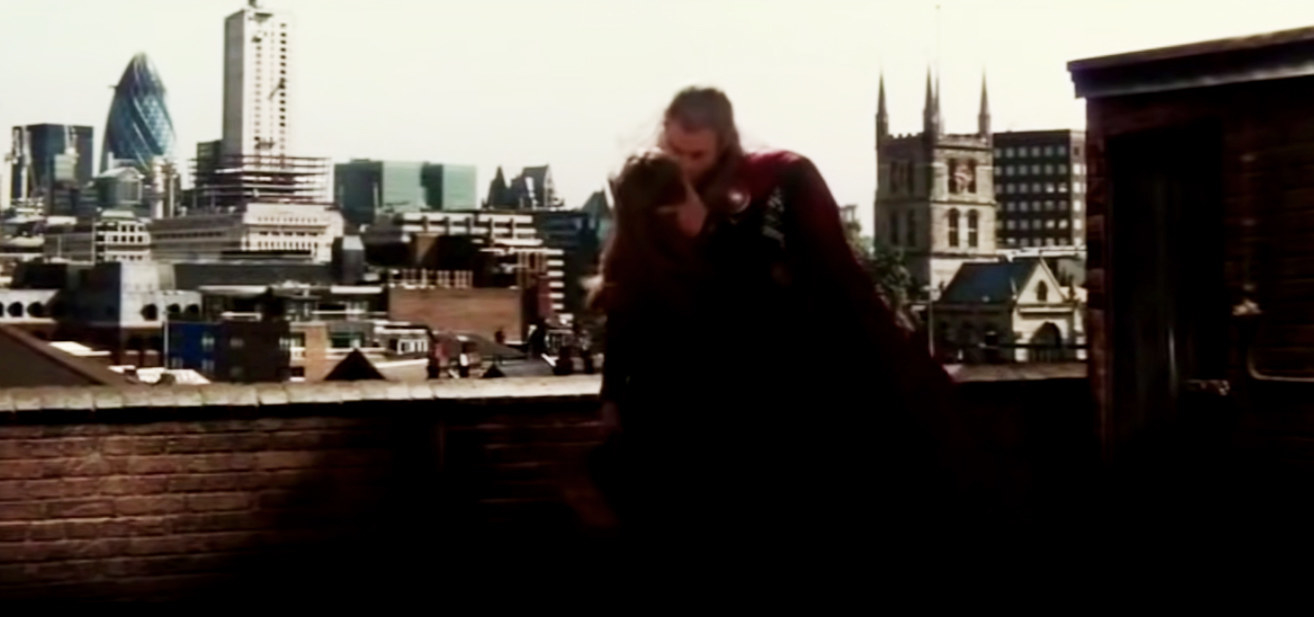Elsa and Chris kissing on a rooftop in the movie