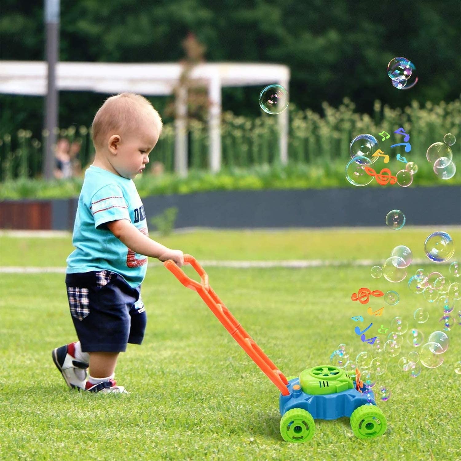 toddler playing with the lawn mower bubble toy outside