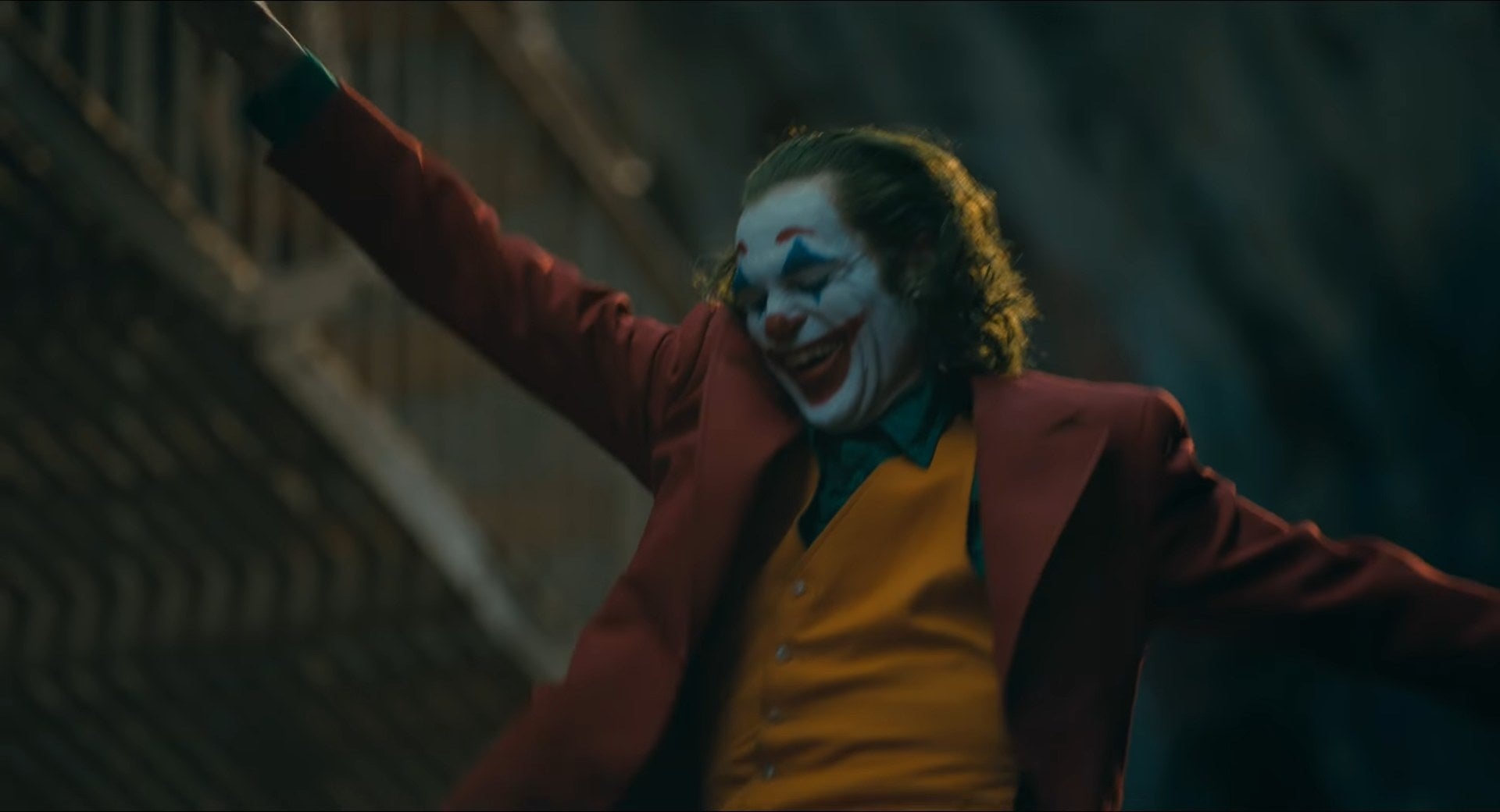 Arthur as the Joker dancing down a flight of stairs in "Joker"