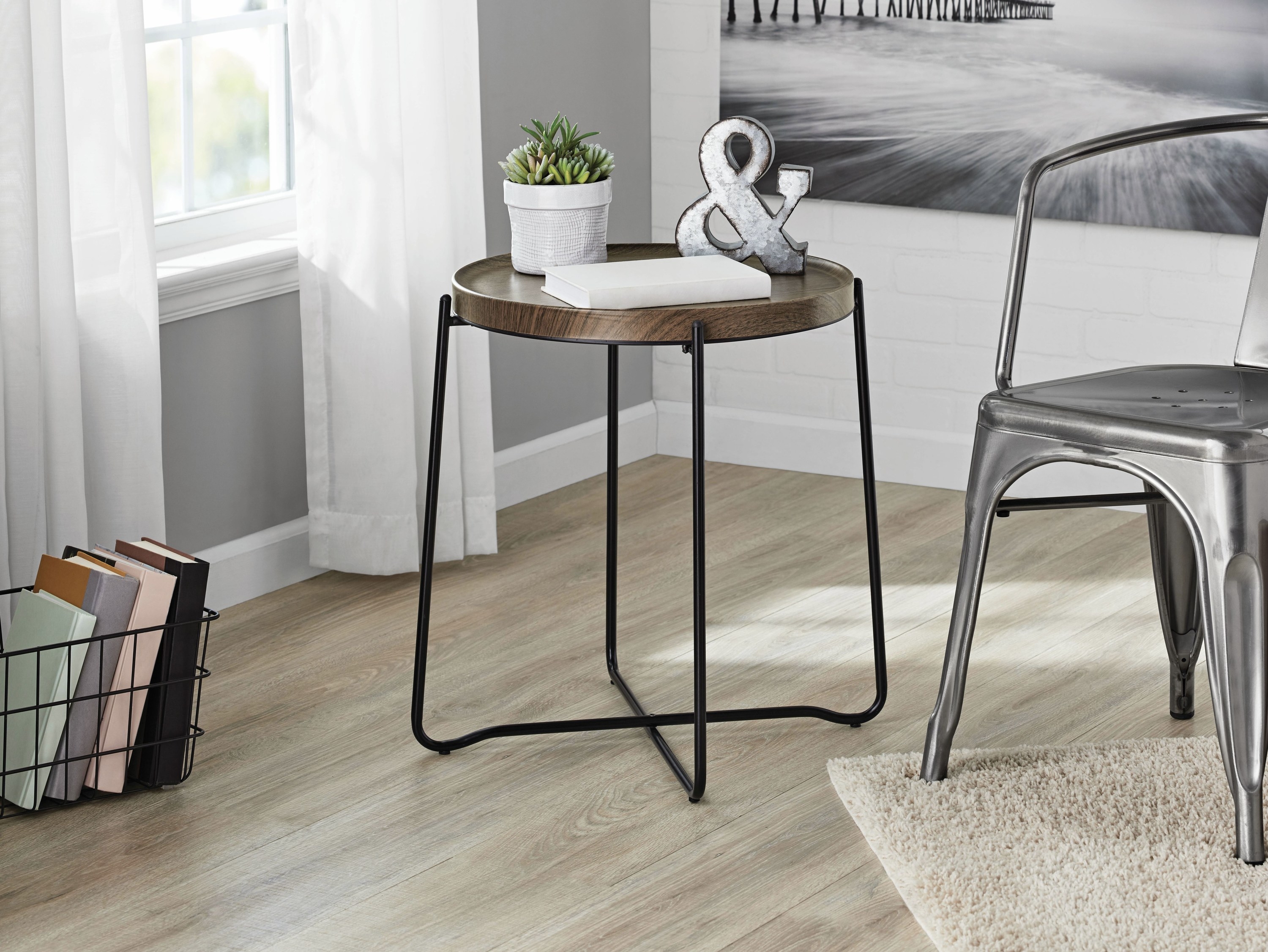 An image of the metal and wood side table inside a bedroom area