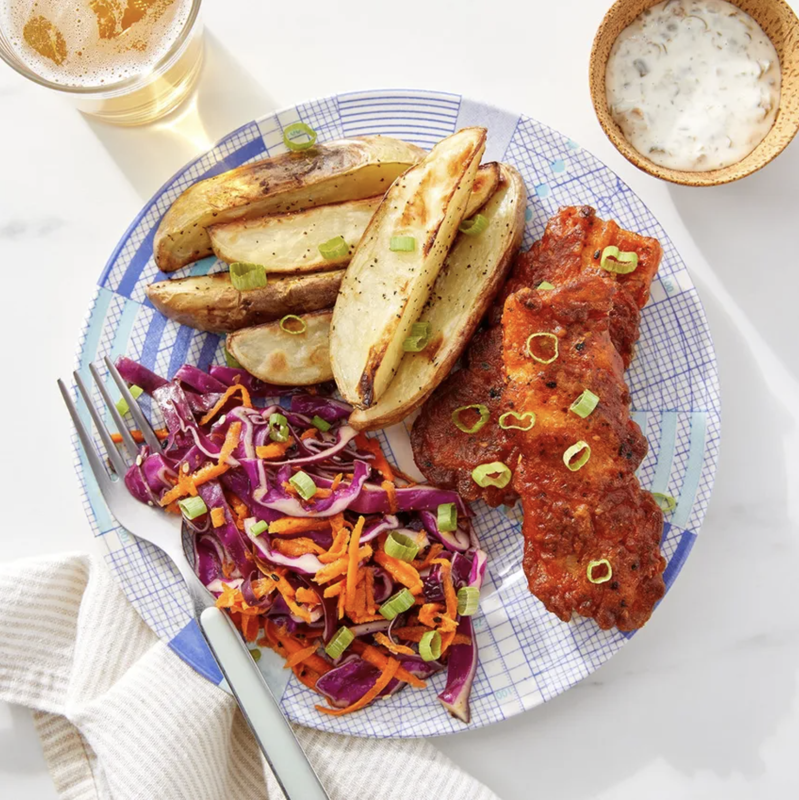 Fish and chips with slaw containing cabbage and carrots