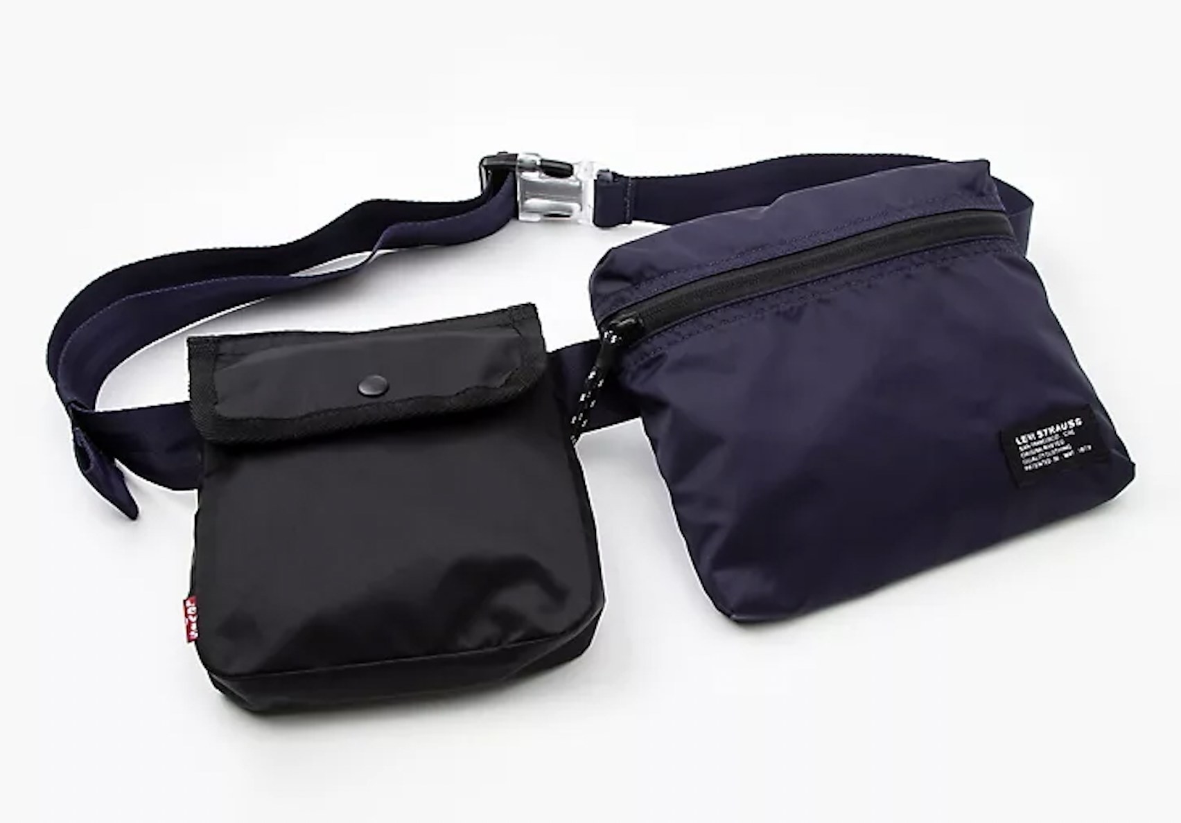 the bag with two compartments: a blue one with a zipper, and a black one with a button flap