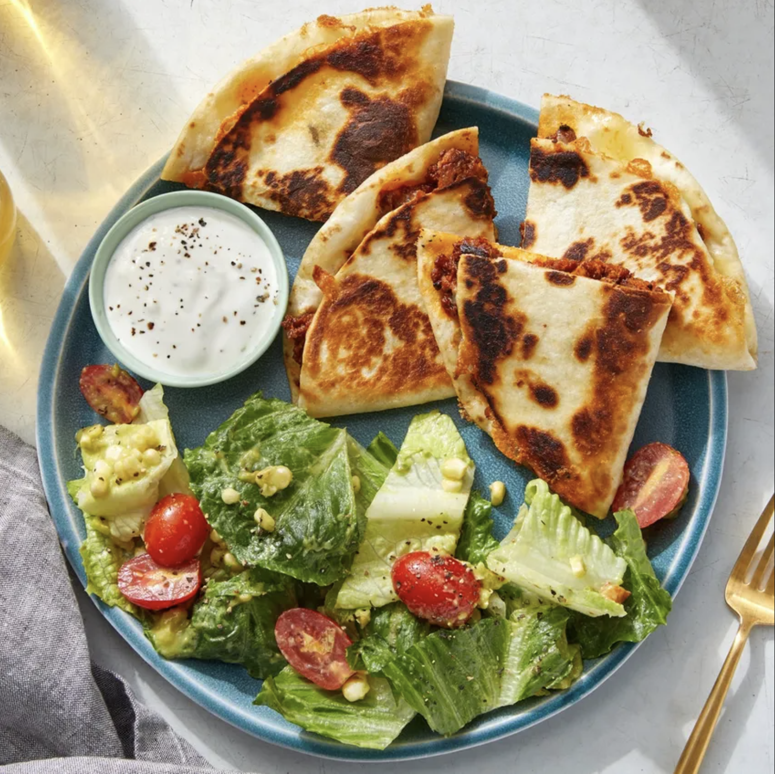 Quesadillas accompanied by salad and dipping sauce
