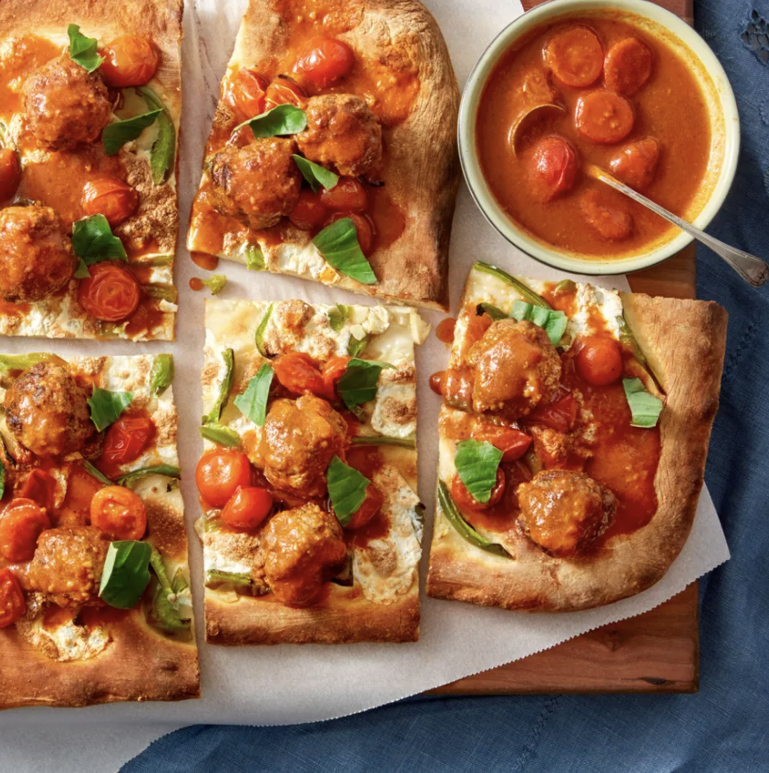 Meatball pizza on parchment paper