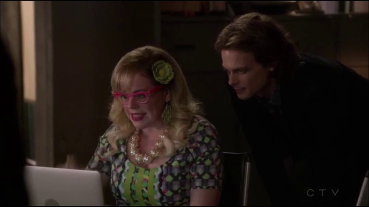 Reid looking over Garcia&#x27;s shoulder as she hacks on the computer