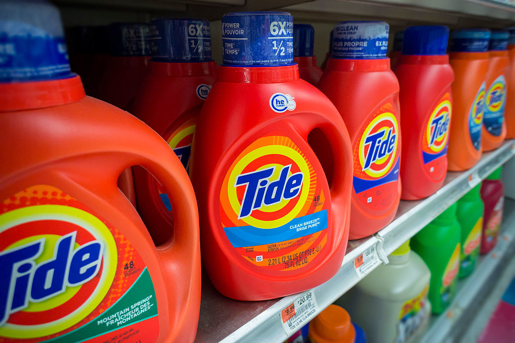 A row of Tide detergent on a supermarket shelf.