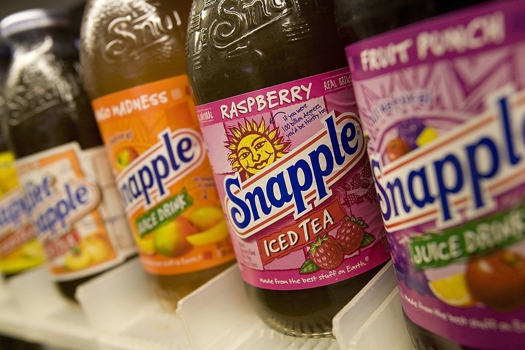 A row of Snapple products on a shelf.