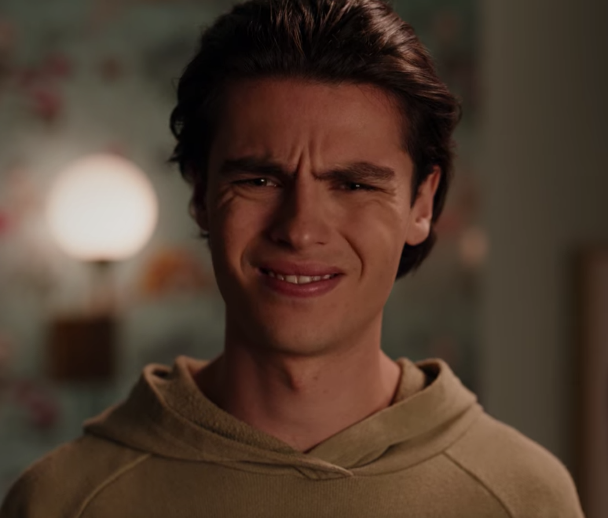 A kid fake smiling, or looking incredulous.