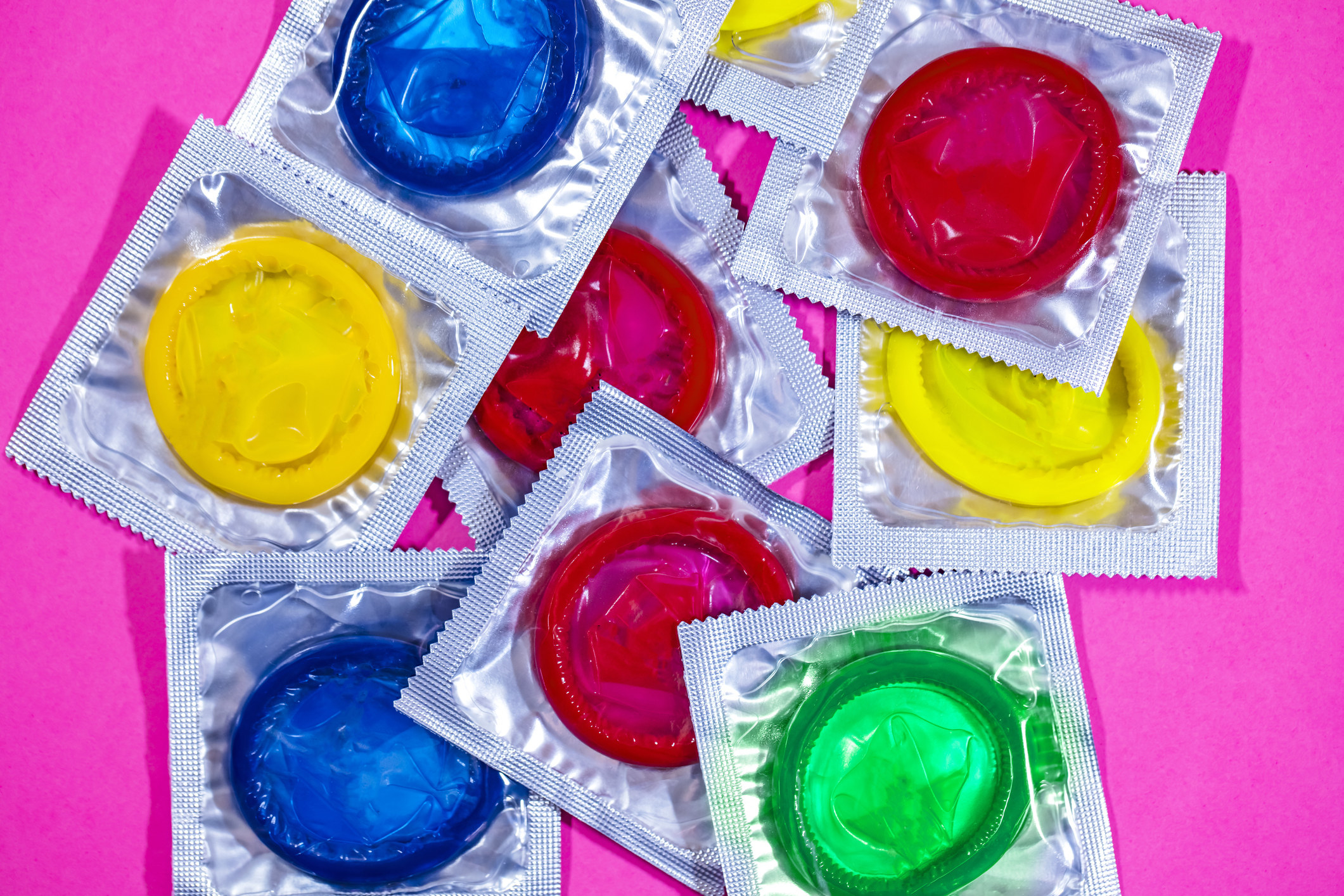 An assortment of different-colored condoms.