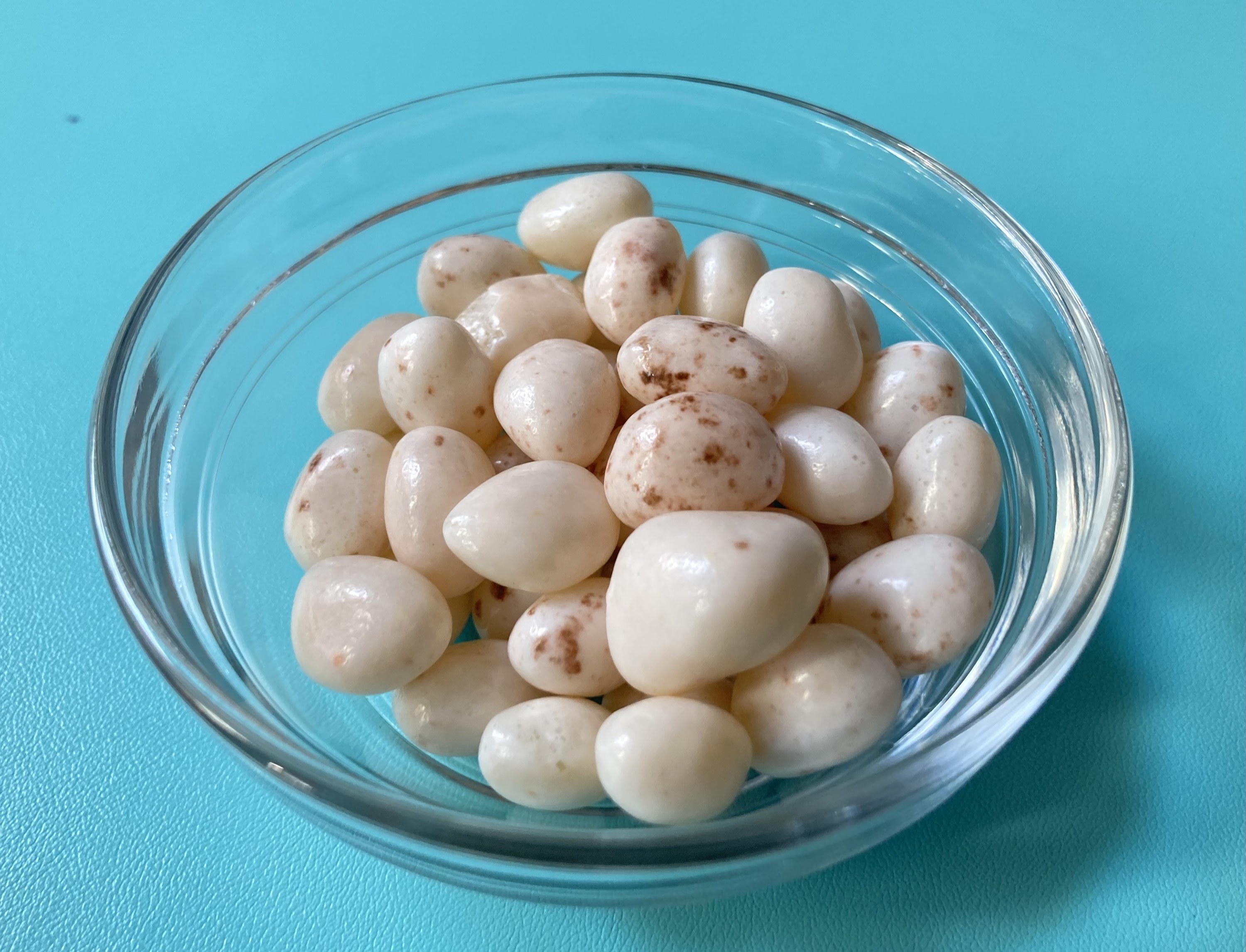 a bowl of white-with-brown-speckles French vanilla jelly beans