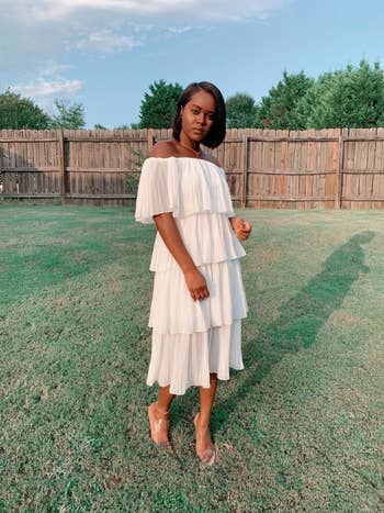 Reviewer waring the beige chiffon off-the-shoulder party dress