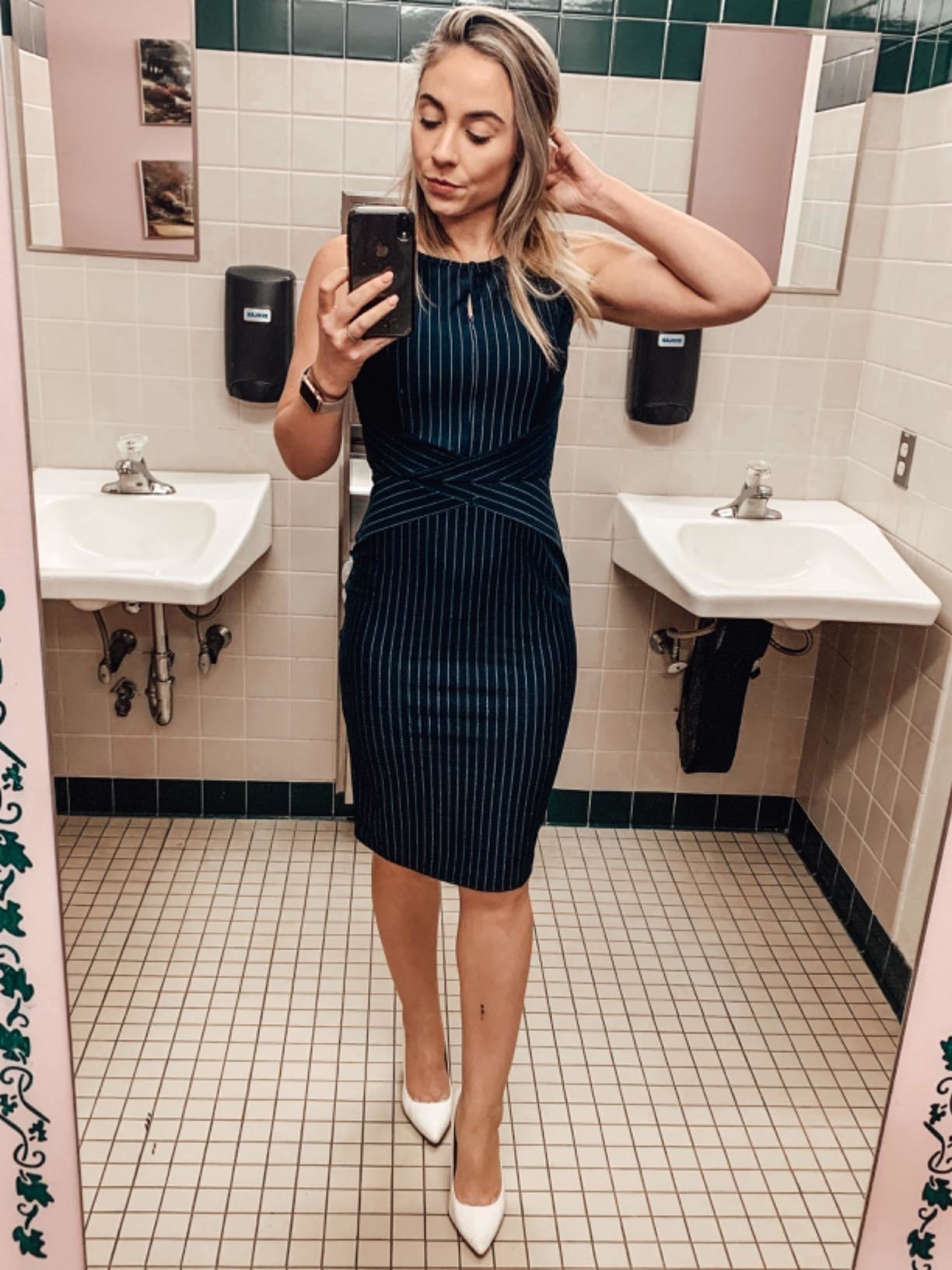 Reviewer wearing the blue and white striped sleeveless pencil dress