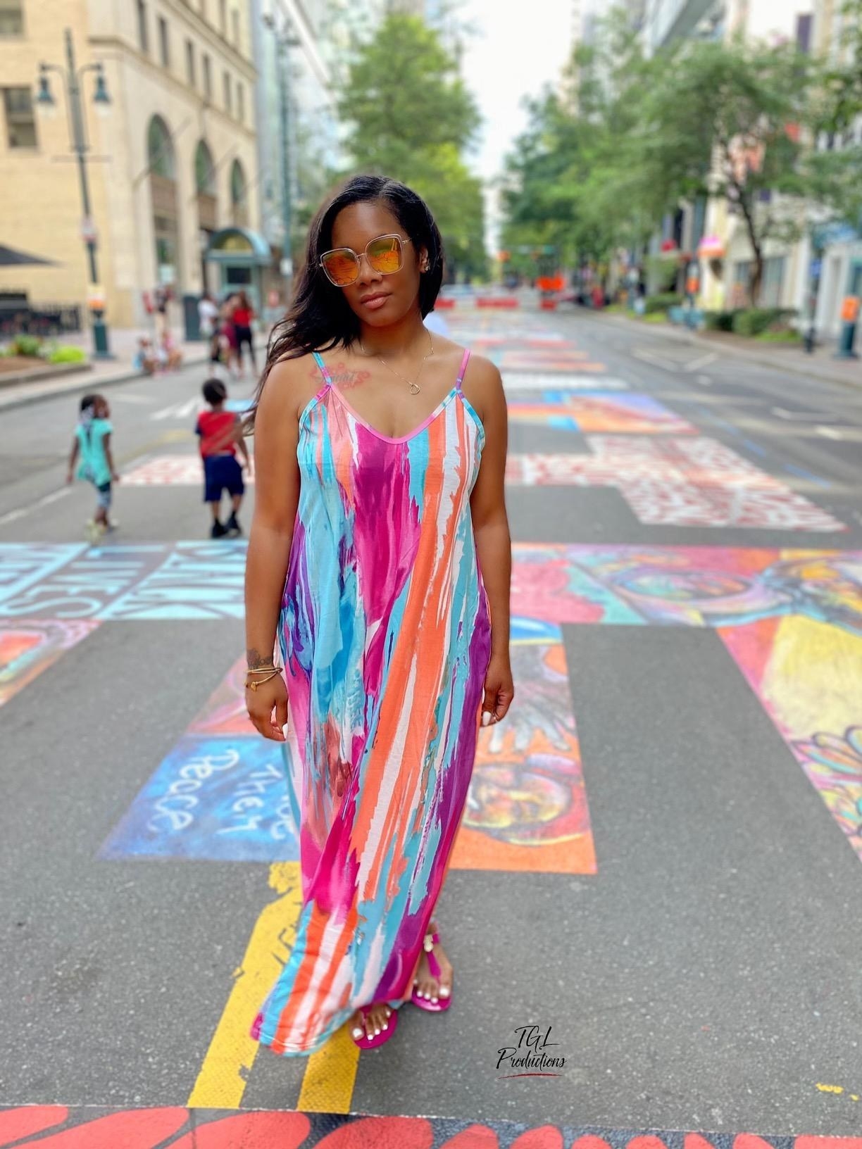 Reviewer wearing the multi-color maxi swing dress