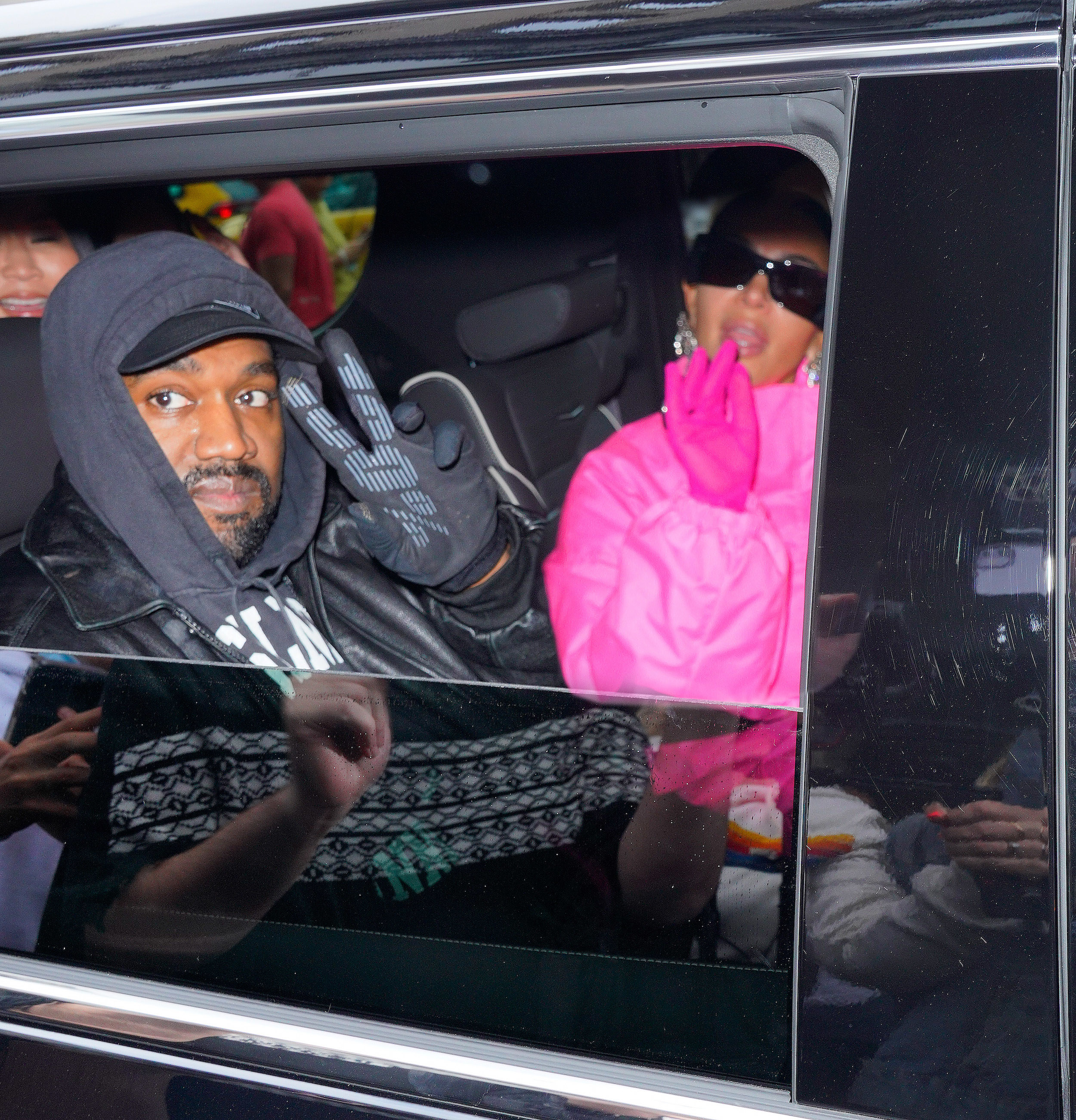 Kanye and Kim sit in the back of a car