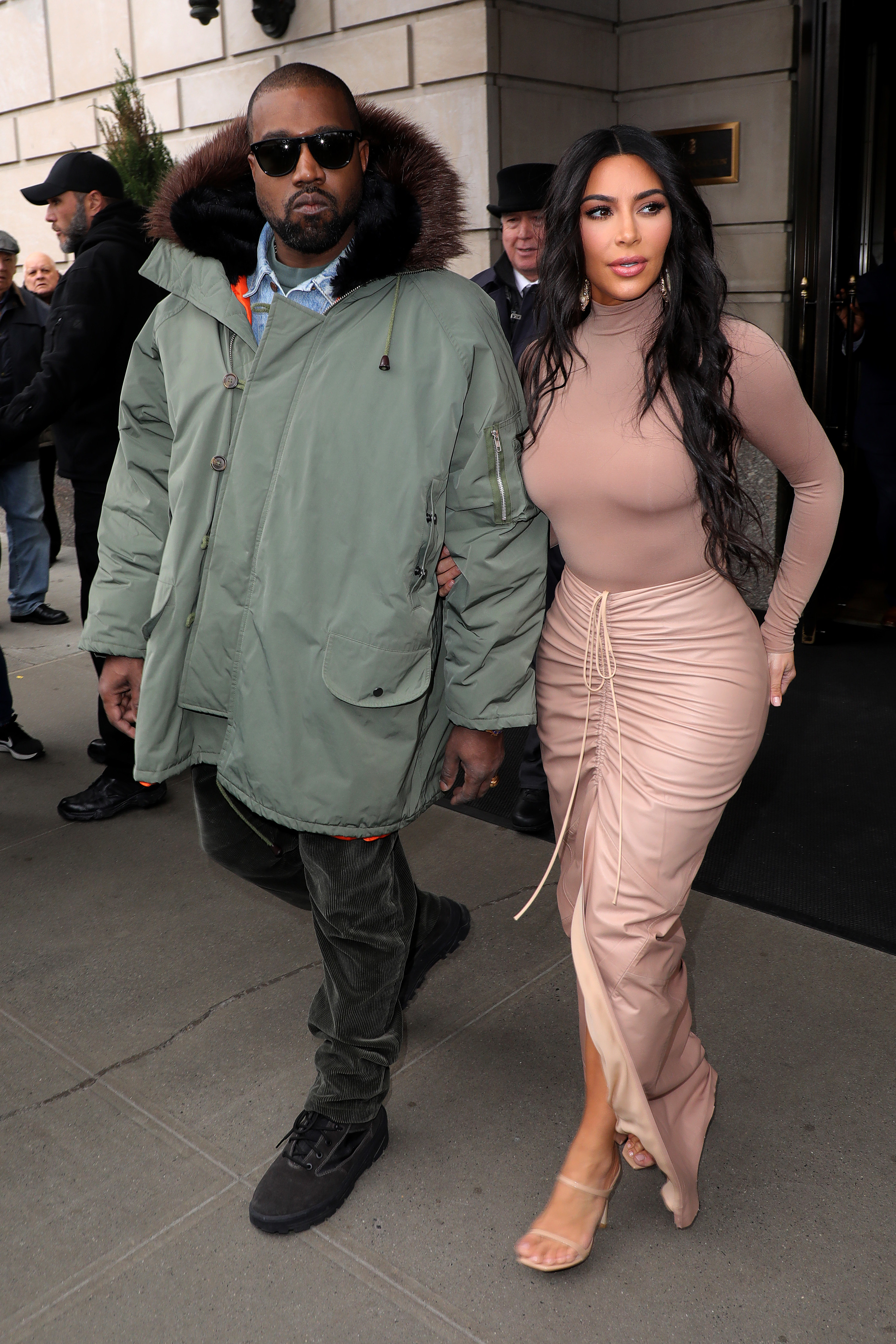 Kanye and Kim walk out of a building together