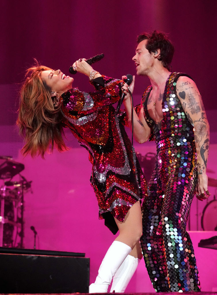 Shanie in a sequined dress while performing with Harry
