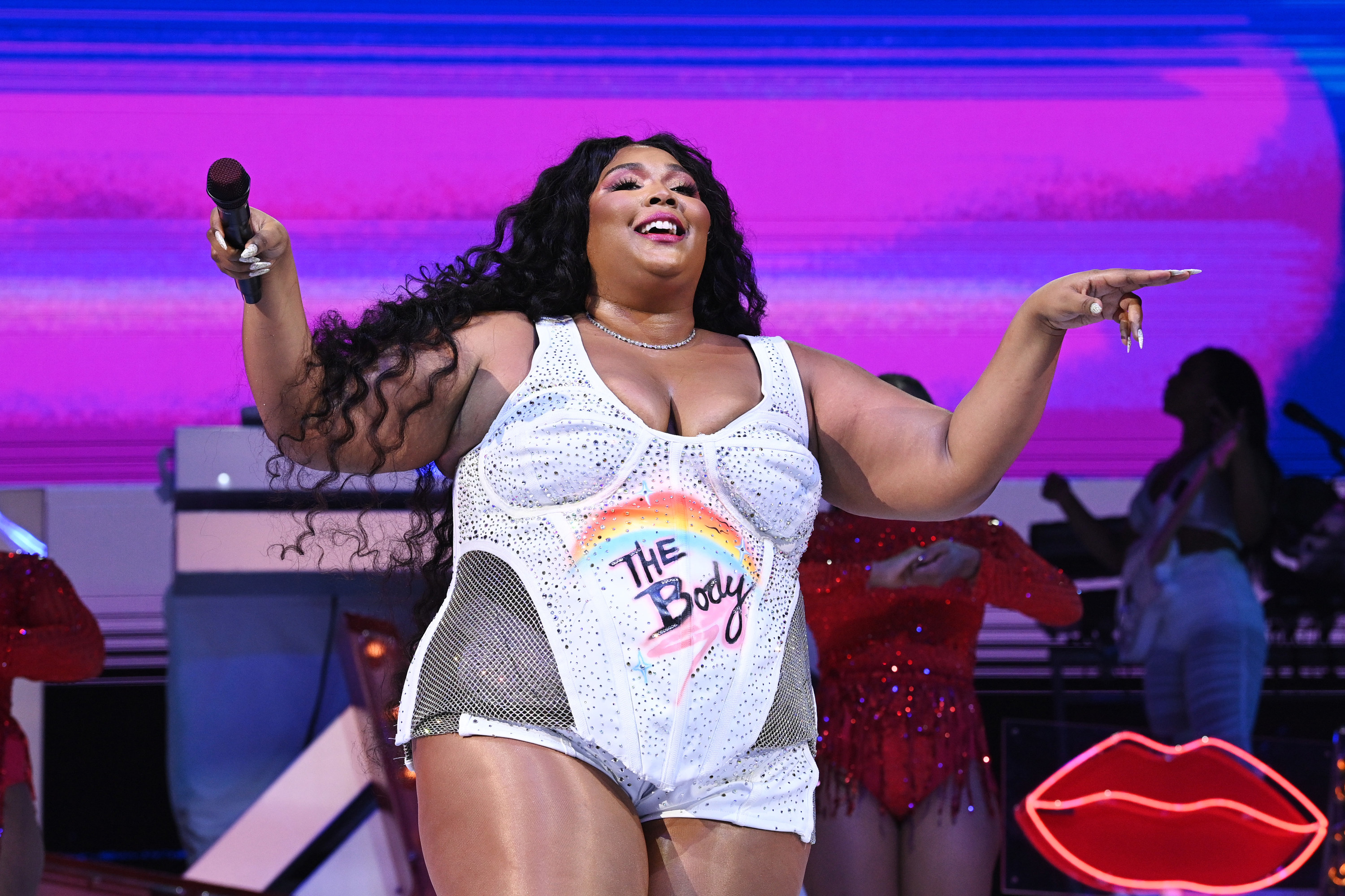 Lizzo puts her microphone out towards the audience