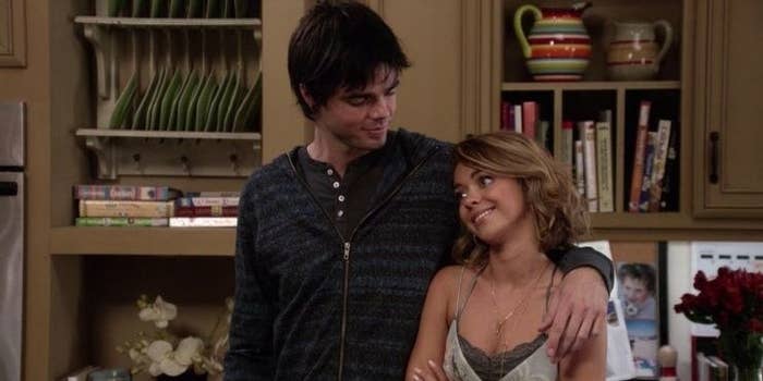 Dylan as he arm around Haley's shoulder as he looks down at her