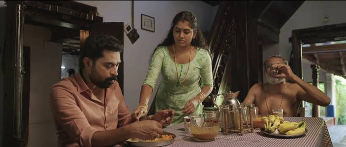 Nimisha Sajayan&#x27;s character serving a meal to her husband and father-in-law.