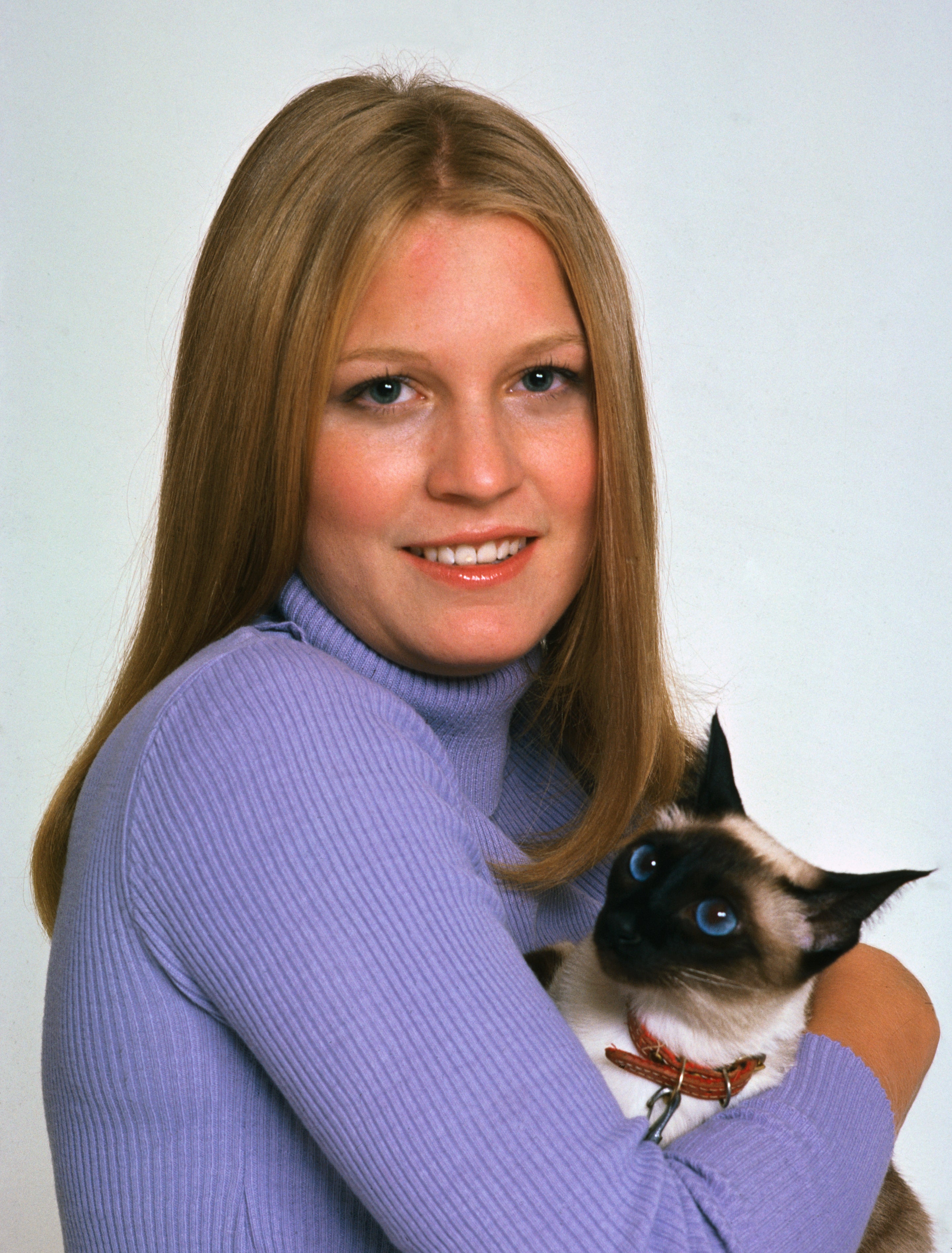 Susan Ford holds her Siamese cat named Shan