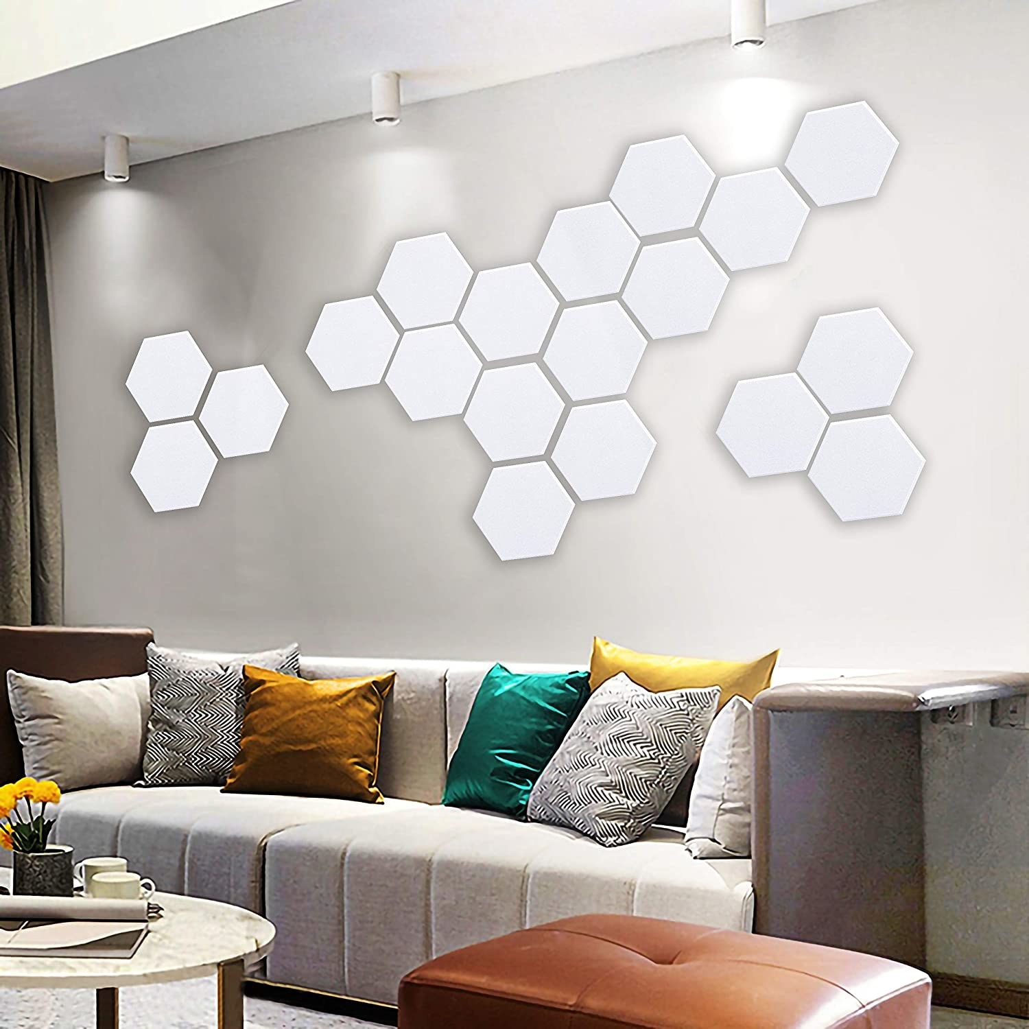 a set of hexagonal soundproofing panels mounted on a wall above a sofa