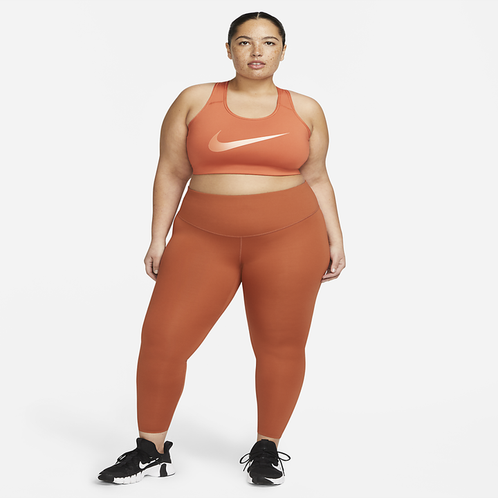 a model posing in burnt orange leggings