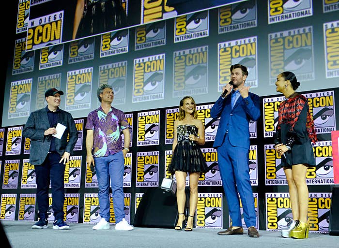 The cast speaking onstage at Comicon