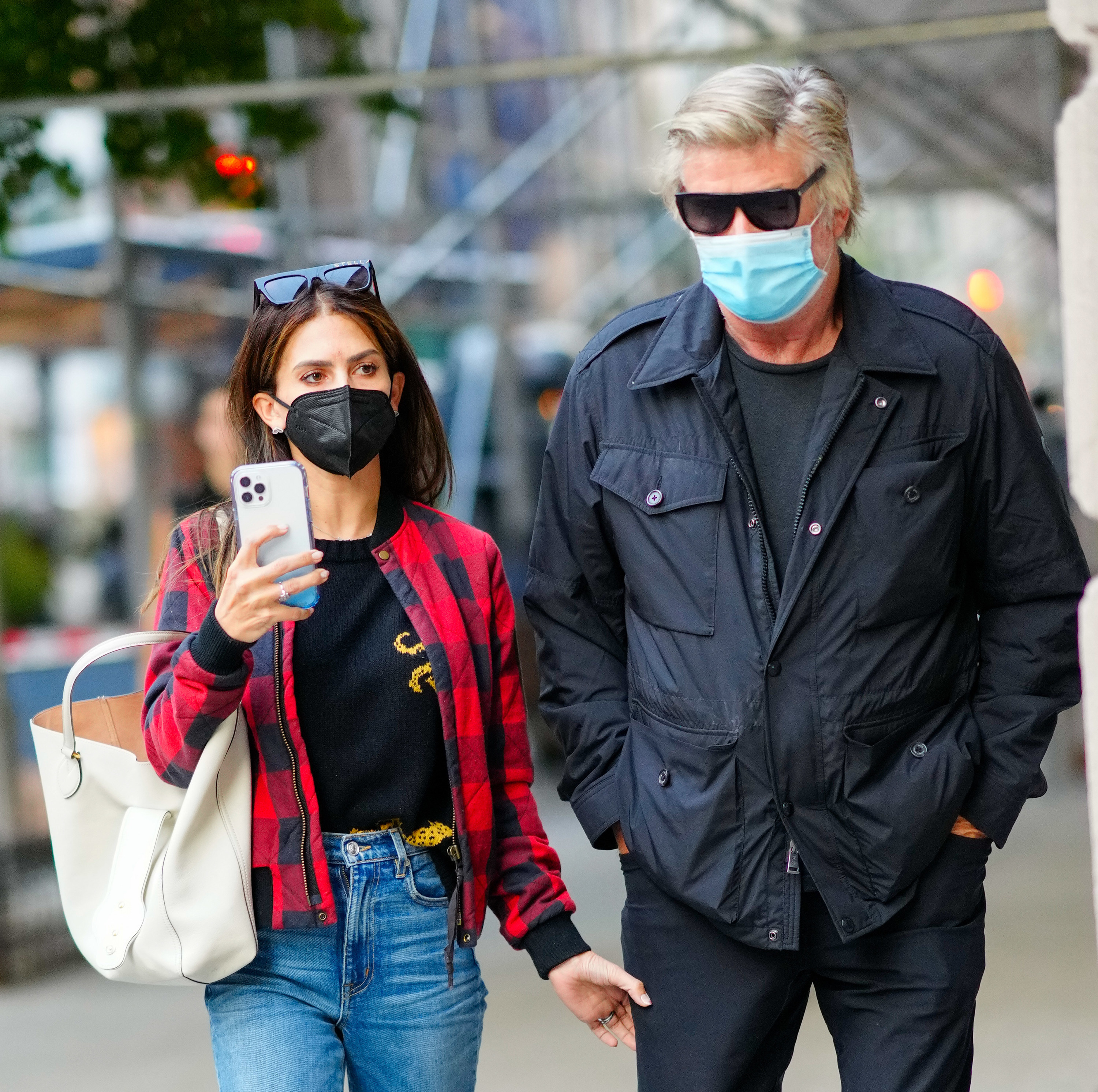 Alec and Hilaria walking outside while wearing face masks