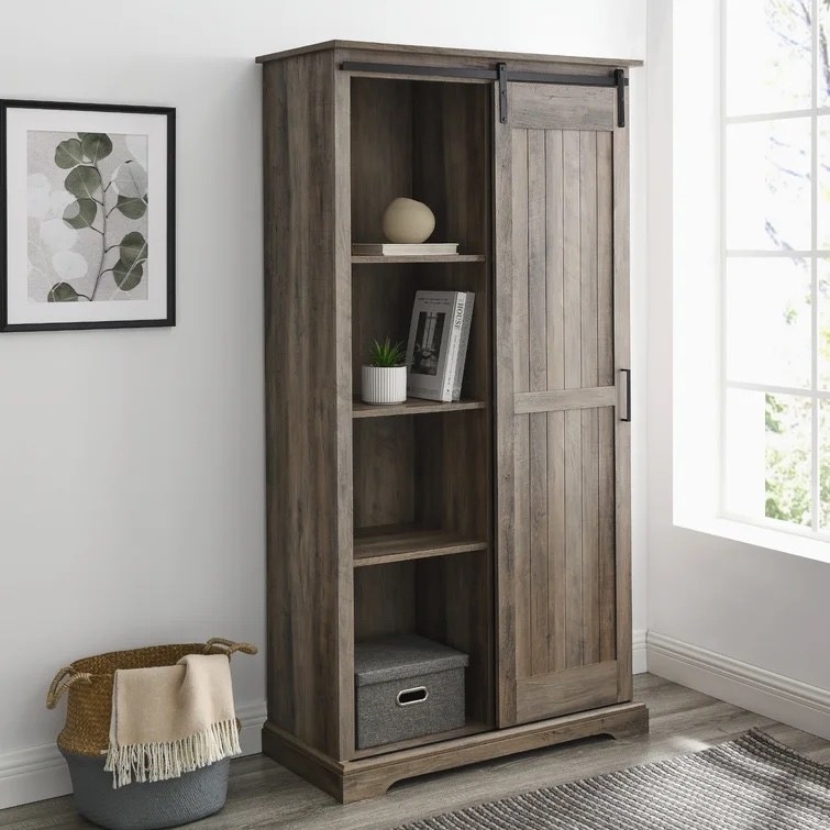the gray armoire with decor items on the shelves