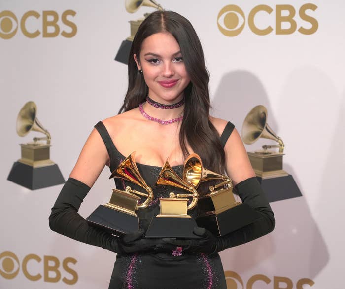 Olivia holding three awards