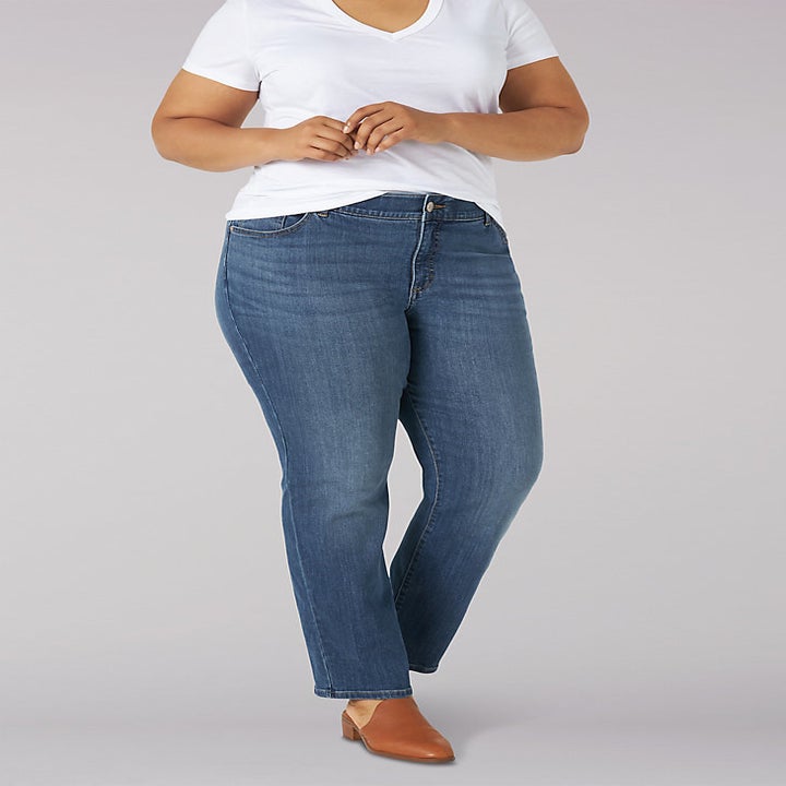 model wearing straight leg blue jeans