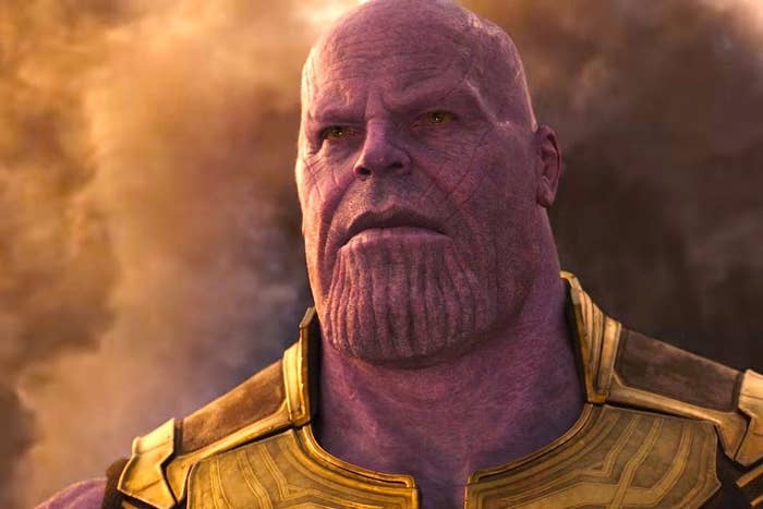 A close up of Thanos as he appears from a cloud of smoke