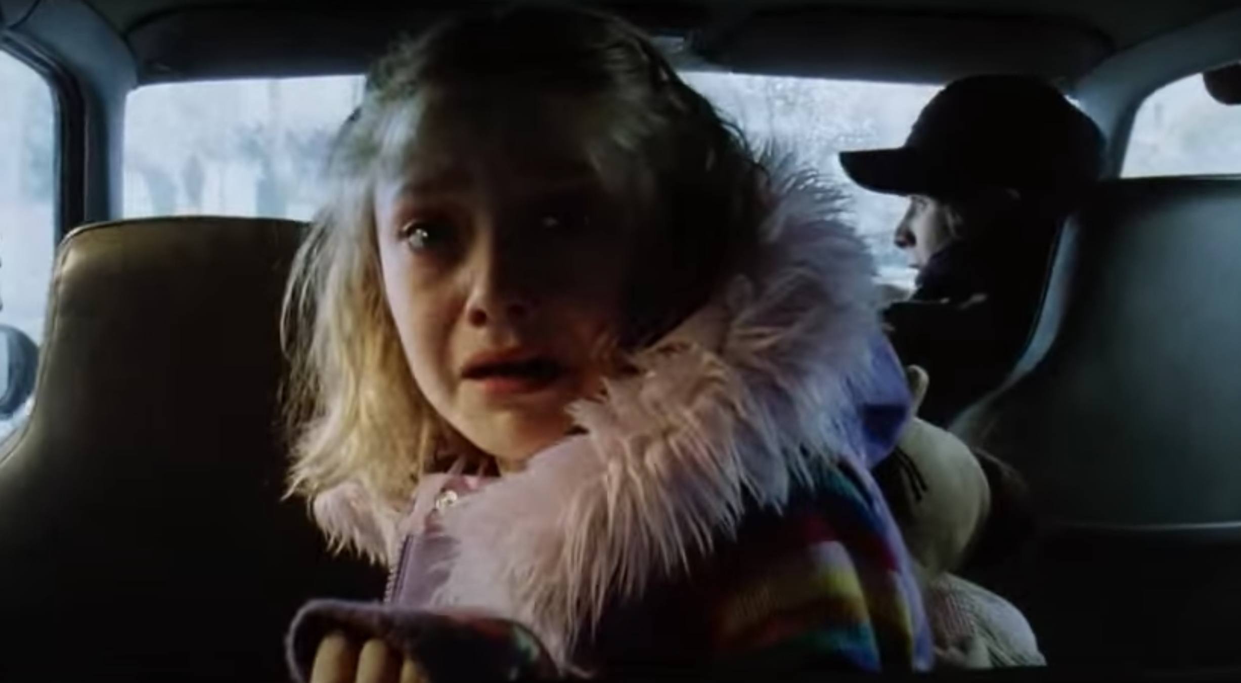 Dakota Fanning in the backseat of a car, looking frightened, in &quot;War of the Worlds.&quot;