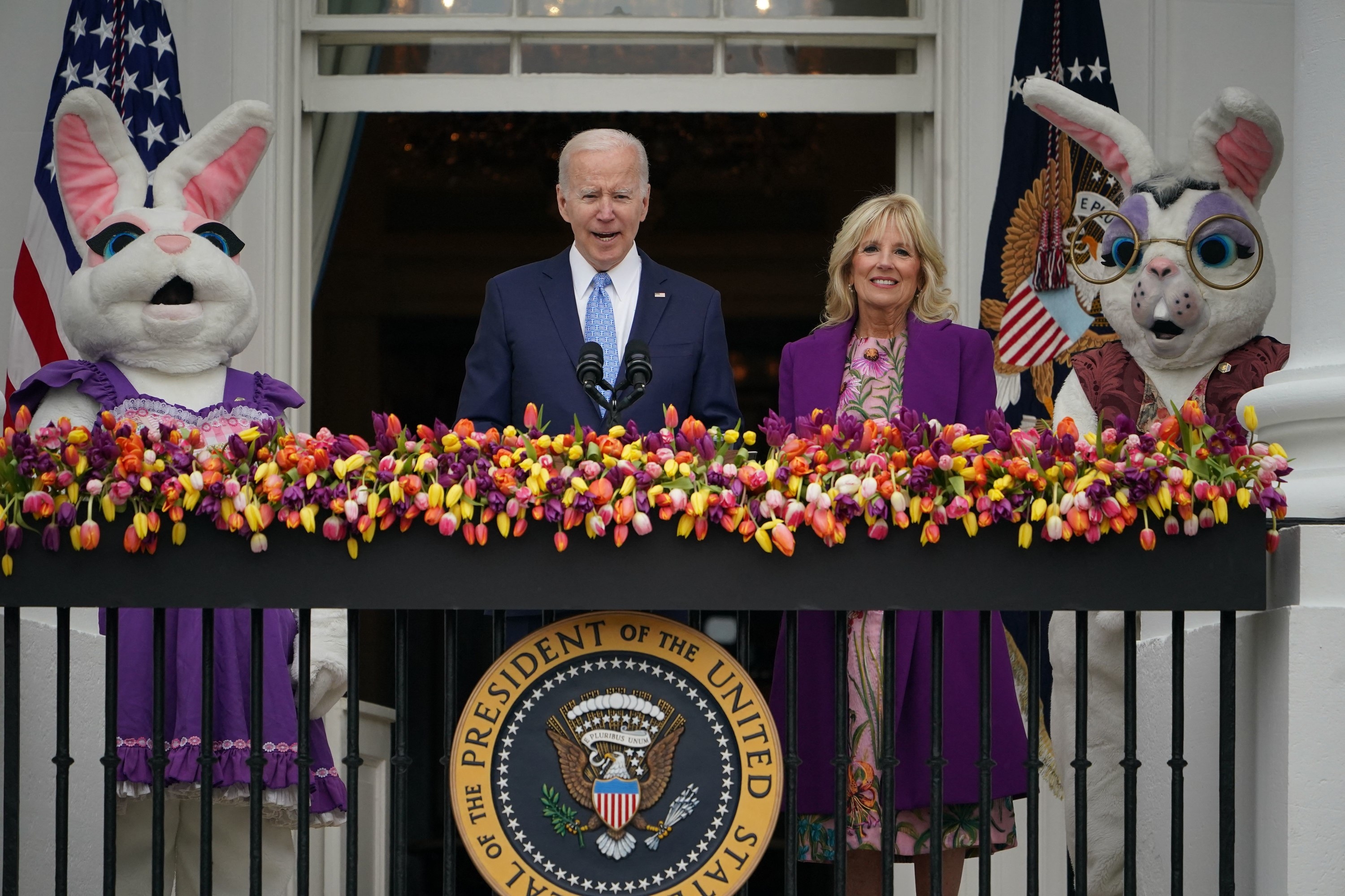 The Bidens speak while two giant costumed bunnies look on