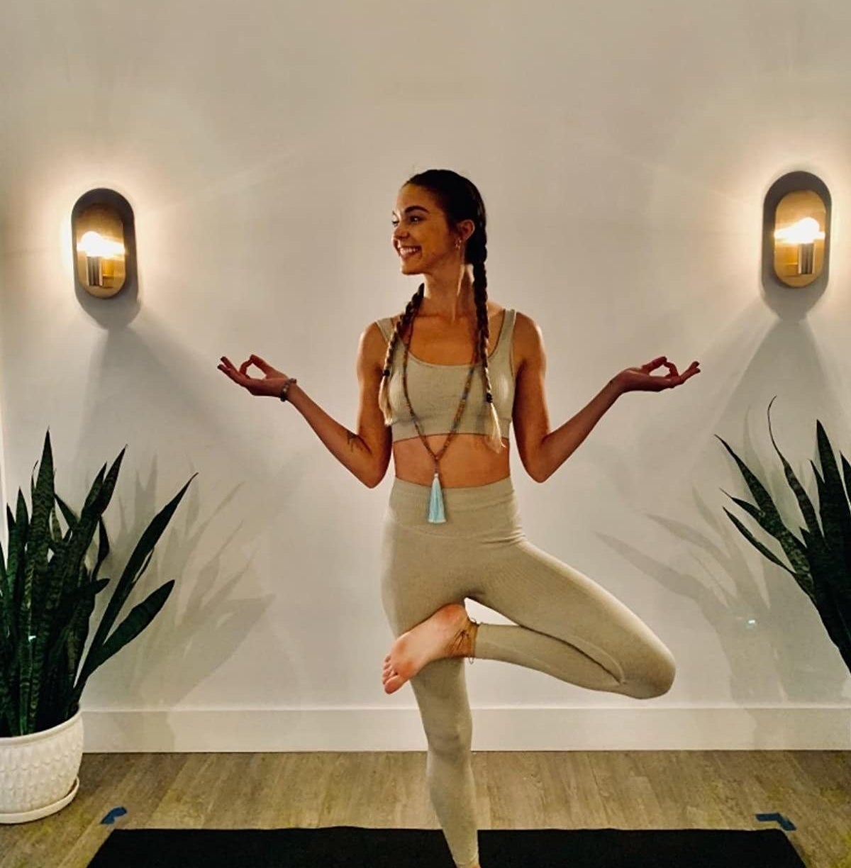 a reviewer wearing the set in khaki while doing yoga