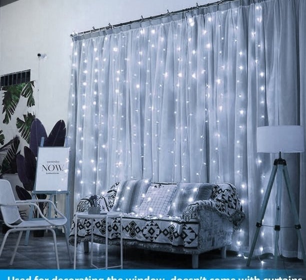 A set of gold fairy lights hanging on a curtain