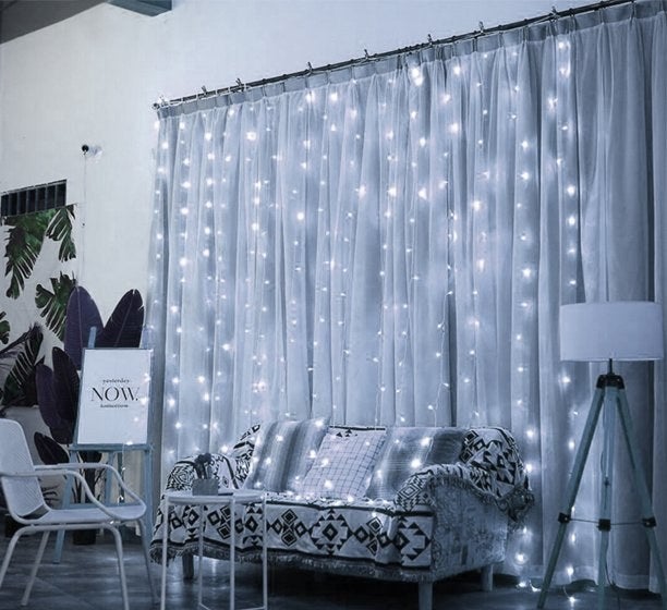 A set of gold fairy lights hanging on a curtain