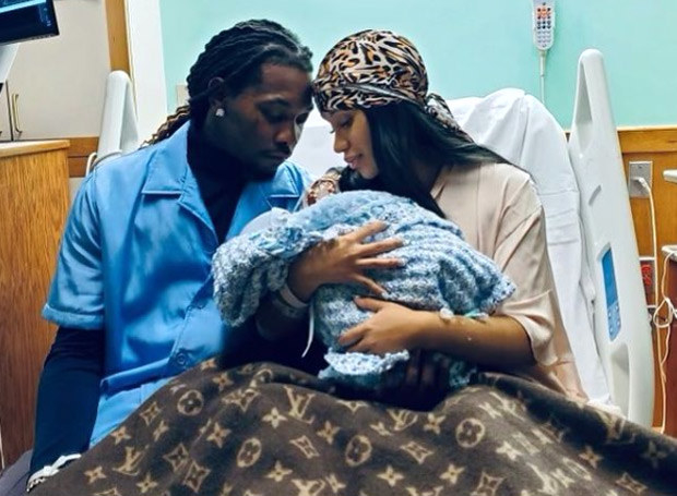 Offset and Cardi B look lovingly at their newborn child in a hospital bed.