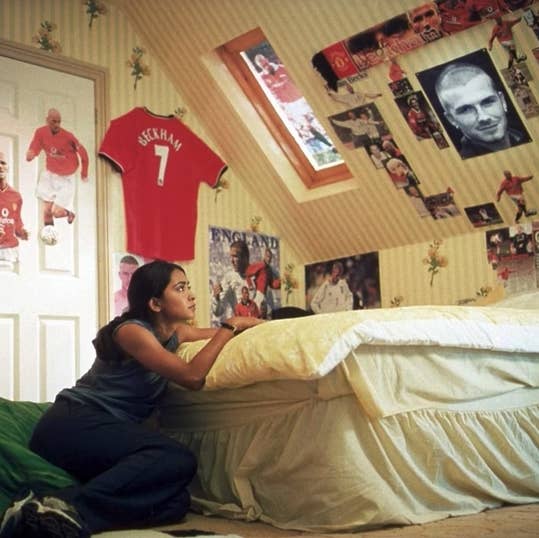 Jess looking up at the David Beckham posters hanging in her bedroom