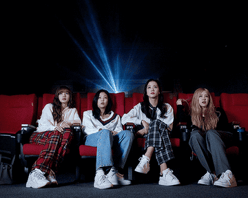 Blackpink sitting in a movie theater